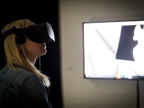 A woman with a virtual reality headset at TIFF Bell Lightbox's Pop 01: VR+ Music + Art exhibit (Photo by Jag Gundu for TIFF)