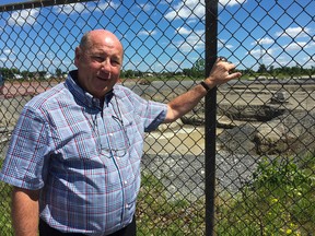 Barry Smith, vice-president of development for the Taggart Group, stands in front of the environmental clean-up work on the former Northern Telecom property where the company is planning a residential and commercial project that also includes a seniors' residence and elementary school in Kingston, Ont. on Thursday June 23, 2016. Paul Schliesmann /The Kingston Whig-Standard/Postmedia Network