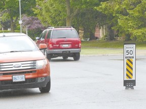 Speed limit signs in the middle of the road on several north London streets, including Glenora Drive shown here, irk a least one Grenfell Drive resident, although the city says the response to the new signs has been mostly positive. (MORRIS LAMONT, The London Free Press)