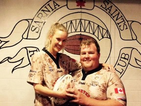 Sarnia Rugby Club representatives Ashlee Liffiton & Stephon Yonge pose in camouflage jerseys they're using in Saints games this Saturday. The games are part of the club's annual Playing it Forward initiative, this year raising cash for a local Afghan War memorial project. (Handout)