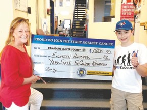Aidan Cyr, 12, turns over a cheque to Joan Bongers of Canadian Cancer Society from the 10th annual Killarney Court street garage sale. (Submitted photo)