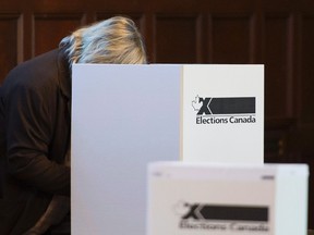 A voter casts their ballot at a polling station in the Montreal riding of NDG-Westmount in the last federal election on Oct. 19, 2015. (THE CANADIAN PRESS)
