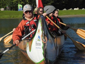 The Kerr family paddles a voyageur canoe around Rotary Park pond on June 18. The Athabasca River Brigade made a stop to Whitecourt to give locals the chance to ride their canoes.