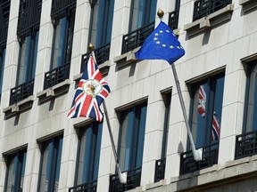A photo taken on June 24, 2016 shows the United Kingdom flag and European flag in front of the U.K. representative to the EU in Brussels. (AFP PHOTO)