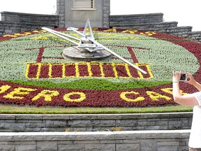 Celebrating the 100th anniversary of the Niagara parks Commission’s Aero Car is the summer design of the floral clock in Niagara Falls. A visitor takes a photo of the hundreds of bedding plants that were used to design the clock face. Built in 1950, the clock is one of the largest in the world at 12.2 metres (40 feet) in diameter. The floral face of the clock is changed twice a season, with Violas being planted in the spring, and traditional carpet bedding though out the summer. (Mike DiBattista/Niagara Falls Review/Postmedia Network)
