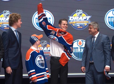 FOURTH PICK: JESSE PULJUJARVI, EDMONTON OILERS
Jesse Puljujarvi, fourth overall pick, pulls on his sweater as he stands on stage after being selected by the Edmonton Oilers at the NHL hockey draft, Friday, June 24, 2016, in Buffalo, N.Y. 
(Nathan Denette/The Canadian Press via AP)