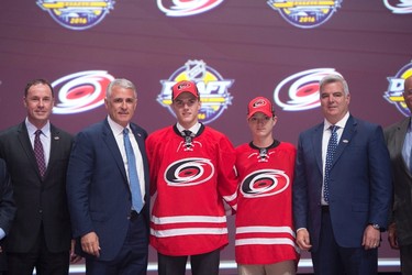 THIRTEENTH PICK: JAKE BEAN, CAROLINA HURRICANES
Jake Bean stands on stage with members of the Carolina Hurricanes management team at the NHL draft in Buffalo, N.Y. on Friday June 24, 2016. 
(THE CANADIAN PRESS/Nathan Denette)