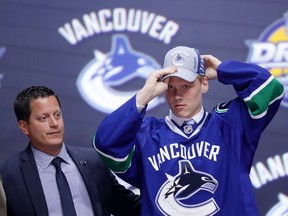 Olli Juolevi, above celebrates after being selected fifth overall by the Vancouver Canucks Friday at the NHL Draft in Buffalo, N.Y. (Bruce Bennett/Getty Images)