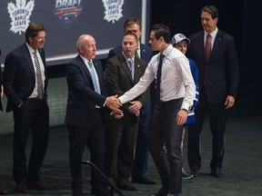 Maple Leafs top pick Auston Matthews shakes hands with MLSE chairman Larry Tanenbaum at the NHL draft. (Ernest Doroszuk, Toronto Sun)