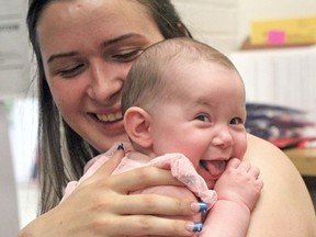 Geraldina Chayer holds her four-month-old, Alaina Wright, while stopping for a visit at Laurentian Learning Centre, Thursday. The 18-year-old mom needed seven credits to graduate last September. She will walk across the stage at West Ferris Secondary School next week to receive her high school diploma.
Jennifer Hamilton-McCharles / The Nugget