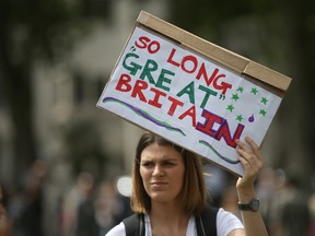 Demonstrators opposing Britain's exit from the European Union in Parliament Square following yesterday's EU referendum result hold a protest in London, Saturday, June 25, 2016. Britain voted to leave the European Union after a bitterly divisive referendum campaign. (AP Photo/Tim Ireland)