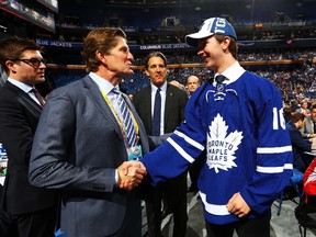 Toronto Maple Leafs Mike Babcock celebrates with Joseph Woll after being selected 62nd during the 2016 NHL Draft on June 25, 2016 in Buffalo, New York.  Bruce Bennett/Getty Images/AFP