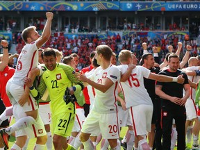 Poland's players celebrate at the end of the Euro 2016 round of 16 soccer match between Switzerland and Poland, at the Geoffroy Guichard stadium in Saint-Etienne, France, Saturday, June 25, 2016. Poland won 5-4 in a shootout. (AP Photo/Darko Bandic)