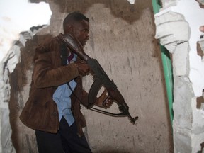 A Somali police officer says a suicide car bomber detonated an explosives-laden vehicle at the gate of a hotel in Mogadishu followed by gunmen who were fighting their way into the hotel. (AP Photo/Farah Abdi Warsameh)