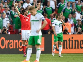 Wales' Gareth Bale, left, celebrates with team mates after winning the Euro 2016 round of 16 soccer match between Wales and Northern Ireland, at the Parc des Princes stadium in Paris, Saturday, June 25, 2016. (AP Photo/Martin Meissner)