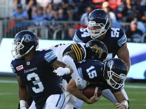 Argonauts quarterback Ricky Ray is sacked during their season-opener against the Hamilton Tiger-Cats on Thursday night. (VERONICA HENRI/Toronto Sun)