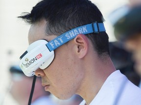 Pilots wear virtual headsets as they compete during the Montreal Drone Expo, Saturday, June 25, 2016. THE CANADIAN PRESS/Graham Hughes