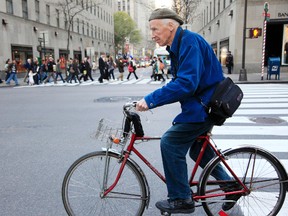 This Nov. 23, 2010 photo shows New York Times photographer Bill Cunningham bicycling to work in New York. Cunningham, a longtime fashion photographer for The New York Times known for taking pictures of everyday people on the streets in New York died on Saturday, June 25, 2016, after suffering a stroke in New York. He was 87. (AP Photo/Mark Lennihan)