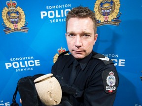 Sgt. Steve Sharpe  holds a lost baby urn that mysteriously showed up in the back of an unregistered vehicle.