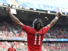 Wales’ Gareth Bale, left, celebrates his team’s victory after the Euro 2016 match against Northern Ireland at the Parc des Princes stadium in Paris Saturday, June 25, 2016. (AP Photo/Martin Meissner)