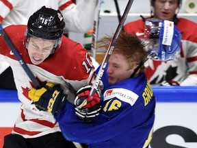 Two possible future teammates, Mitch Marner (left), of Team Canada, and Sweden’s Carl Grundstrom collide at the world junior championship last year. Marner was the Maple Leafs’ top pick in the 2015 draft, while Grundstrom was selected 57th overall by the team yesterday. (The Canadian Press)
