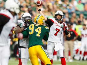 Ottawa's Trevor Harris (7) throws the ball to Ernest Jackson (9) during a CFL game between the Edmonton Eskimos and the Ottawa Redblacks at the Brick Field at Commonwealth Stadium in Edmonton on Saturday, June 25, 2016.