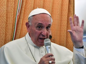 Pope Francis talks to journalists during a press conference he held on board the airplane on his way back to the Vatican, at the end of three-day visit to Armenia, Sunday, June 26, 2016. (Tiziana Fabi/Pool photo via AP)