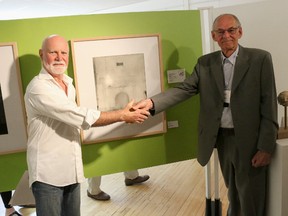 The 23rd Annual Art in the County Juried Exhibition and Sale kicked off Friday at Books $ Company in Picton. The show, featuring the work of Prince Edward County artists runs until July 10. Pictured is Graham Davies (left), being congratulated by Otto Rogers with his winning piece, Falconer House.