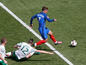 Ireland's Shane Duffy clips France's Antoine Griezmann during the Euro 2016 Round of 16 soccer match between France and Ireland at the Grand Stade in Decines-Charpieu, near Lyon, France, on June 26, 2016. (AP Photo/Michael Sohn)