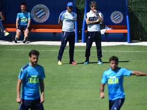Italy's coach Antonio Conte (left) and team manager Gabriele Oriali watch their players during a training session in Montpellier, southern France, on June 9, 2016. (AFP PHOTO / SYLVAIN THOMAS)