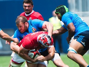 Canada's Jamie Cudmore is tackled by Italy's Lorenzo Cittadini at BMO Field on Sunday. (Nathan Denette/The Canadian Press)