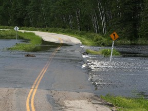 Water rushes across Highway 44 at McGillivray Falls in Whiteshell Provincial Park on Sun., June 26, 2016. Kevin King/Winnipeg Sun/Postmedia Network