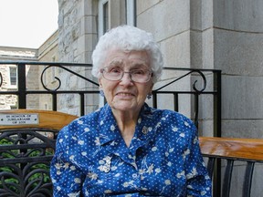 Sister Anna Moran, who turned 100 years old on Sunday, June 19, poses for a photograph while sitting on the bench at the front of Sisters of Providence of St. Vincent de Paul Mother House in Kingston, Ont. on Thursday June 23, 2016. Julia McKay/The Whig-Standard/Postmedia Network