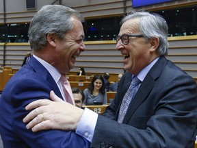 Nigel Farage (L), Britain's UK Independence Party (UKIP) leader and European Commission President Jean Claude Juncker (R) take part in a plenary session at the European Parliament on the outcome of the "Brexit" summit, in Brussels February 24, 2016. REUTERS/Yves Herman