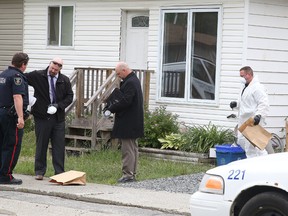 Greater Sudbury Police officers, detectives and forensic officers investigate a semi-detached home at 11B Peter St.  in Copper Cliff, Ont. on Sunday June 26, 2016. A 34-year-old man suffered life-threatening injuries during an altercation with a 31-year-old man from St. Charles who was arrested and charged with attempted murder. The injured male was transported to Health Sciences North, where he remains in critical but stable condition. Gino Donato/Sudbury Star/Postmedia Network