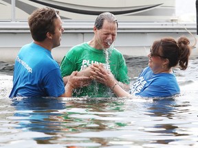 Pastors Amanda Robichaud and Joshua Sklar of All Nations church preside overfull immersion in water baptism to John Chiarot during Plunge in the Park at Bell Park  in Sudbury, Ont. on Sunday June 26, 2016. Gino Donato/Sudbury Star/Postmedia Network