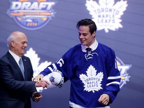 Auston Matthews celebrates onstage with the Toronto Maple Leafs after being selected first overall by the Toronto Maple Leafs during round one of the 2016 NHL Draft on June 24, 2016 in Buffalo, New York. (Bruce Bennett/Getty Images/AFP)