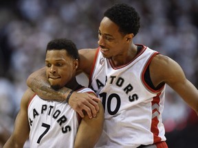 Toronto Raptors' DeMar DeRozan and Kyle Lowry celebrate during a timeout in the fourth quarter of Eastern Conference semifinal NBA playoff action against the Miami Heat in Toronto on May 15, 2016. (THE CANADIAN PRESS/Frank Gunn)