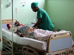 A person is treated, at a public hospital in Antananarivo, Madagascar, Monday, June 27, 2016, a day after an explosion at a stadium.  A grenade exploded in a stadium in Madagascar, killing two people and injuring more than 80 in what authorities describe as a terrorist attack, authorities said Monday. (AP Photo/Jeanne Richard)