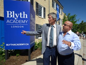 Sam Blyth, founder and owner of Blyth Academy, left, talks with London developer Shmuel Farhi Monday, following the announcement the private school will be moving into the former Labatt buildings on Ridout Street. (MORRIS LAMONT, The London Free Press)