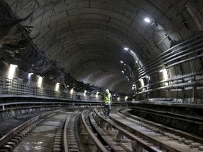 A man walks on the railroad of a metro line extension under construction near Nossa Senhora da Paz station in Rio de Janeiro, Brazil, Feb. 24, 2016. (REUTERS/Ricardo Moraes)