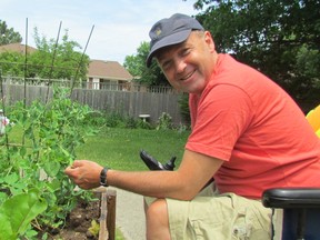 Greg Beauchamp checks on his garden on Thursday June 23, 2016 in Sarnia, Ont. The Sarnia man who has limited mobility has been able to return to gardening after neighbours helped him assemble raised planters in the yard at the apartment buiilding where he lives.
Observer Staff/Sarnia Observer/Postmedia Network