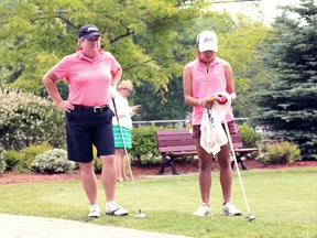 Mary Anne Hayward (left) and Diana McDonald (right), finalists in the 67th Annual Cataraqui Field Day and Empire Life Eastern Provinces Golf Championships, wait to tee off at the Cataraqui Golf and Country Club on Monday. (Julia Balakrishnan/For The Whig-Standard)