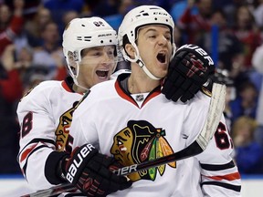 Chicago Blackhawks forward Andrew Shaw, right, is congratulated by teammate Patrick Kane after scoring during playoff action against the St. Louis Blues, Friday, April 15, 2016, in St. Louis. (THE CANADIAN PRESS/AP, Jeff Roberson)
