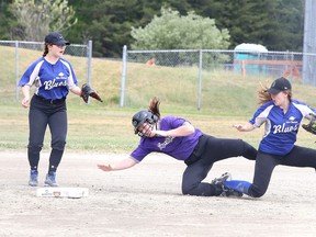 Renee Bisier of Autobuff is tripped up as she is tagged out by Brooke Lacey of the Skin Clinique Blues during Bantam B division championship game action during the girls fastball tournament in Sudbury, Ont. on Sunday June 26, 2016. Gino Donato/Sudbury Star/Postmedia Network