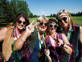 From left, Tammy Halina, Caren Bilyk, Dorothy Casey and Janice Sadownyk flash peace signs during the 2016 Tiara "Hippy" Classic at Mill Woods Golf Club on Monday. (Codie McLachlan)