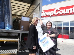 Sleep Country Canada co-founder and executive co-chair Christine Magee looks on as Marlene Gorman, executive director at YWCA Genevra House, checks out a mattress  on Monday .Gino Donato/Sudbury Star/Postmedia Network