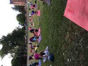 Some of the over 67 participants learn some yoga during the June 22 Yoga on the Green event.