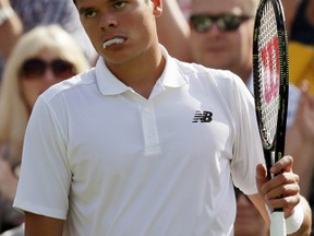 Milos Raonic of Canada looks out at the crowd during his men's singles match against Pablo Carreno Busta of Spain on Day 1 of the Wimbledon Tennis Championships in London on June 27, 2016. (AP Photo/Tim Ireland)