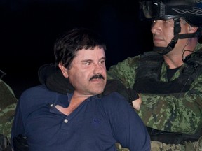 In this Jan. 8, 2016 file photo, Joaquin "El Chapo" Guzman is made to face the press as he is escorted to a helicopter in handcuffs by Mexican soldiers and marines at a federal hangar in Mexico City, Mexico.  (AP Photo/Marco Ugarte, File)